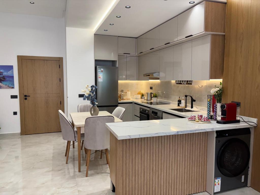 a large kitchen with a table and chairs in it at Riviera garden 9 in Cabo Negro
