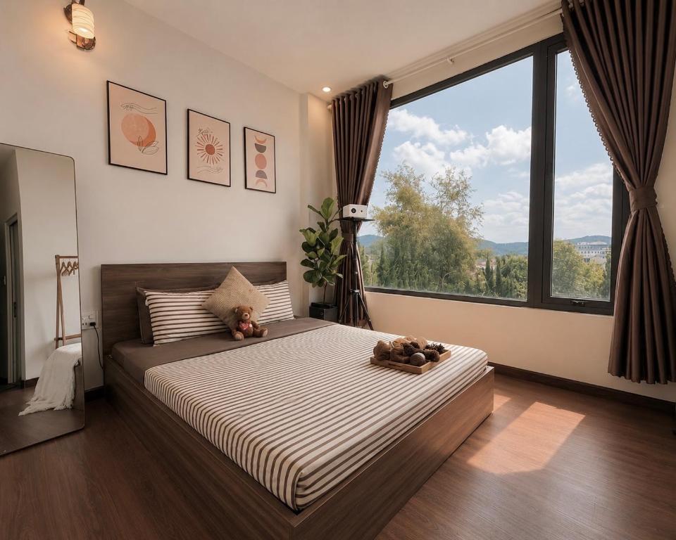 a bedroom with a large bed with two teddy bears on it at 1 House 2 in Da Lat