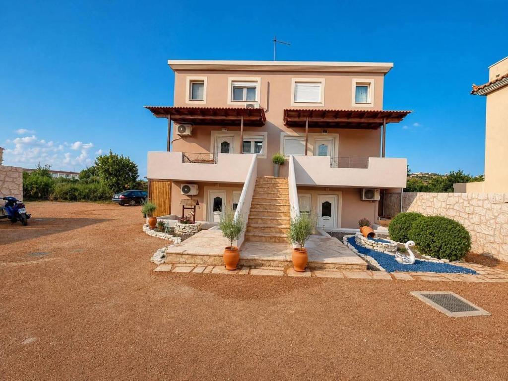 a house with a staircase in front of it at The Mastiha Spot 3 in Chios