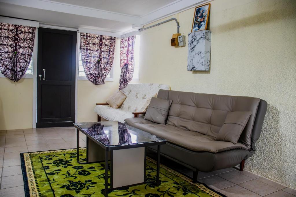 a living room with a couch and a table at Tanuli Heights in Honiara