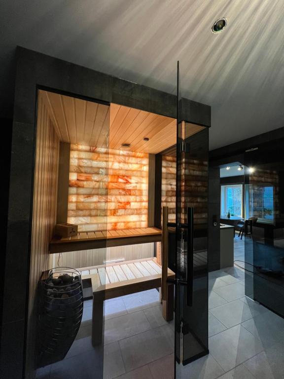 a room with a bench and a glass wall at Jolster SPA apartments for 2 in Skei