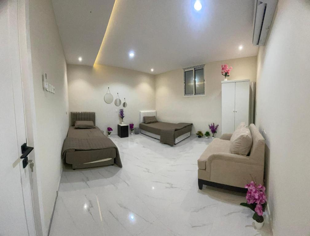 a living room with two couches and a couch at Green Stays in Comilla