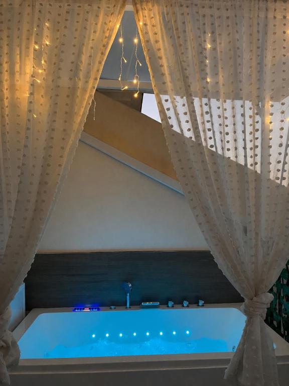 a swimming pool in a room with a curtain at Balcón de La Iruela II in La Iruela