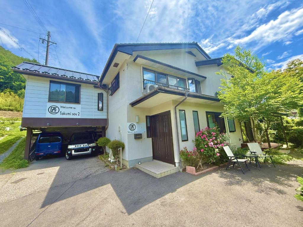 a house with a truck parked in front of it at Takumisou 2 in Kiso