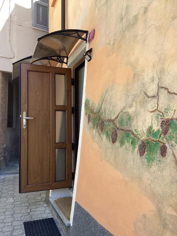 a door with a painting on the side of a building at Alle Fucine in Mallare