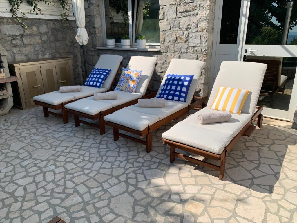 a group of chairs sitting on a patio at Delux apartment Dora with a private parking in Rijeka