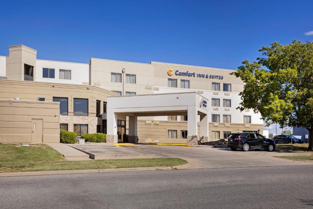 a building with a car parked in front of it at Comfort Inn & Suites Wichita Northeast in Wichita