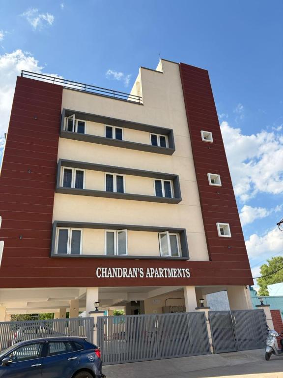 a building with a car parked in front of it at Chandran Apartments in Vellore