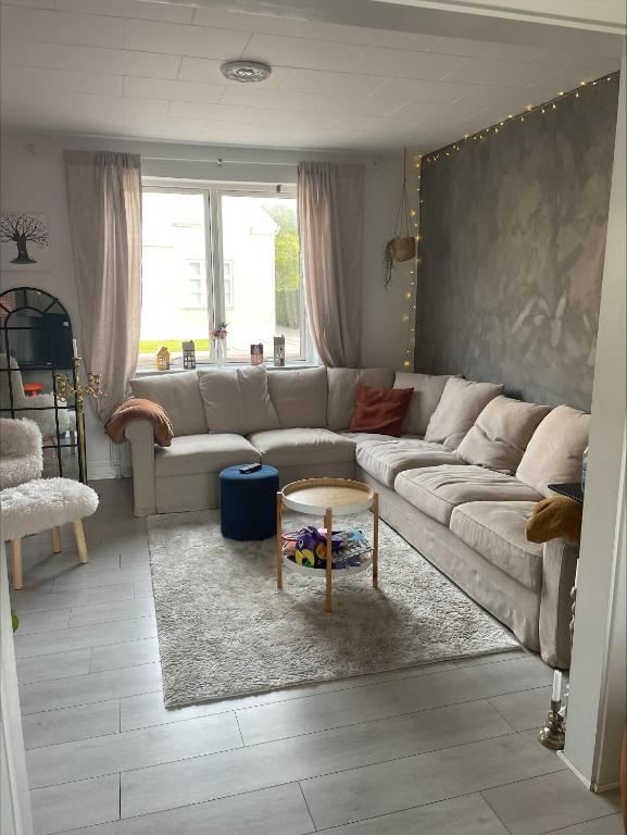 a living room with a couch and a table at Hyggely in Nakskov
