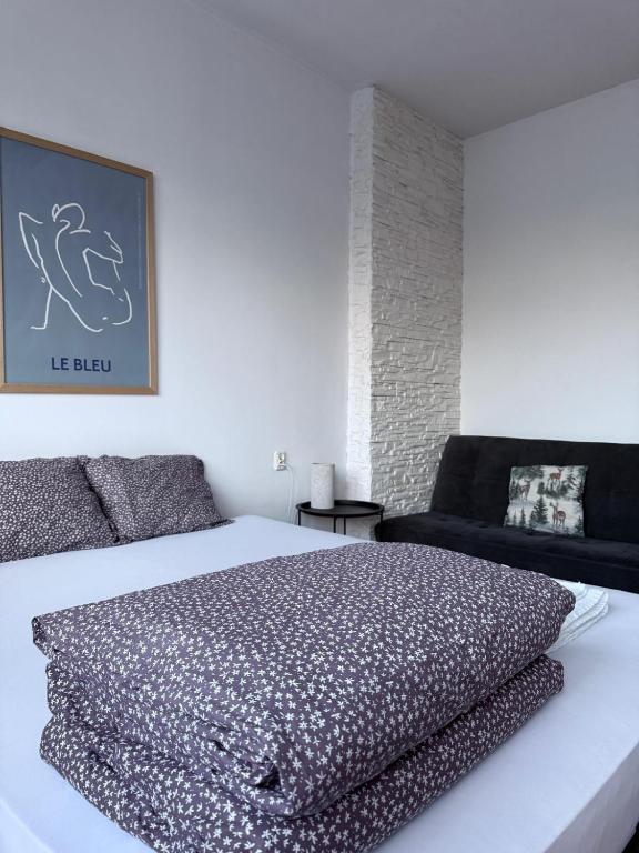 a bedroom with a large bed and a couch at Sunhaus in Gdynia