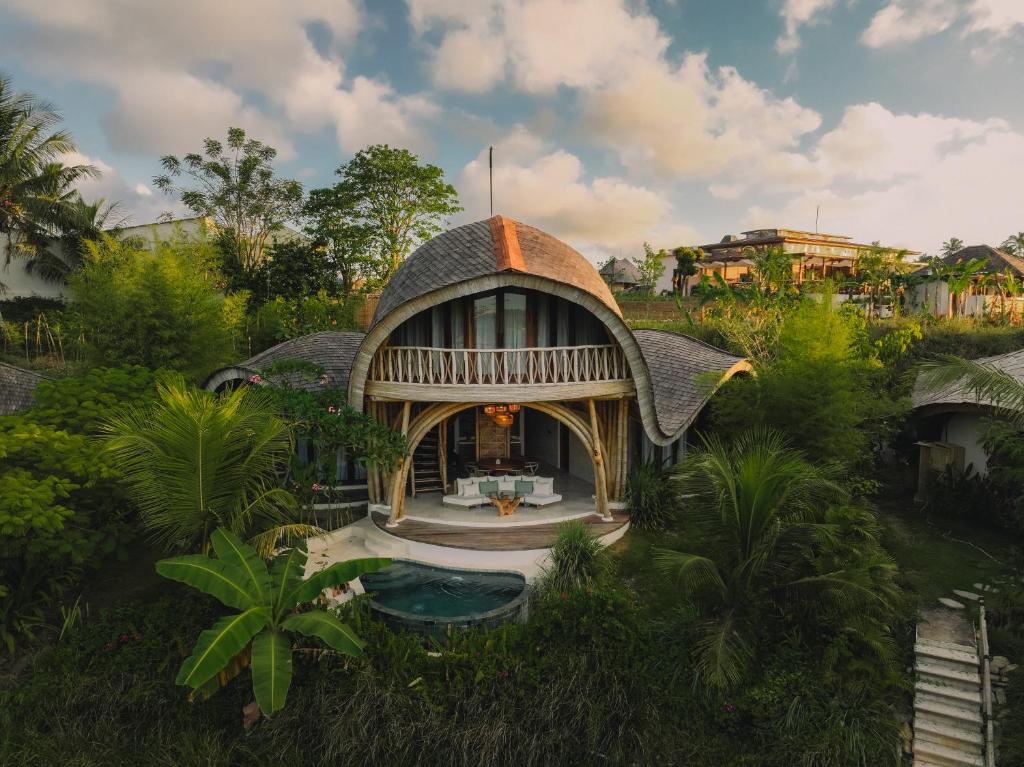 an overhead view of a house with a thatched roof at Mandala Eco Resort Lombok in Selong Belanak