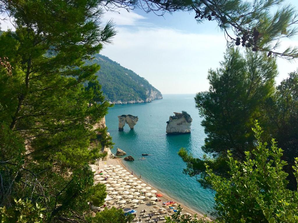 a view of a beach with rocks in the water at AH Premium Baia dei Faraglioni in Mattinata