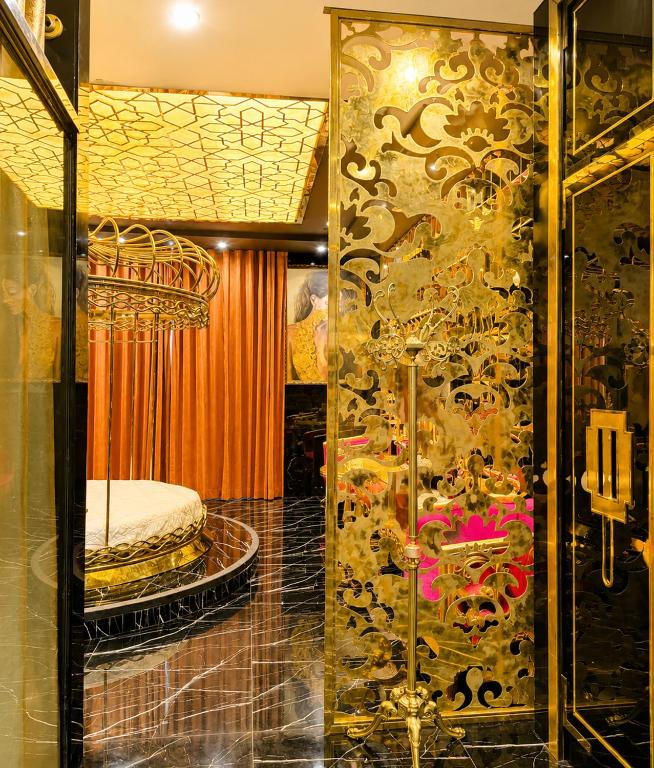 a room with a bed and a glass door at Athena Hotel Huế in Hue