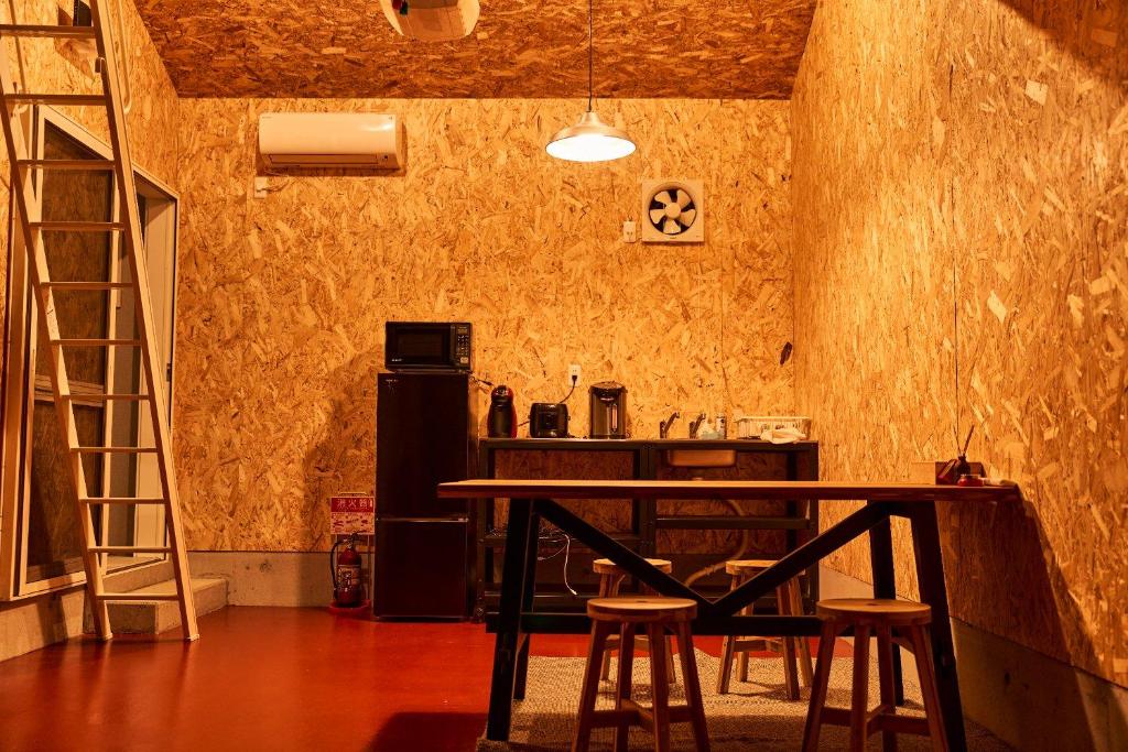 a kitchen with a table and chairs in a room at POPFIRE TOWN in Shirako