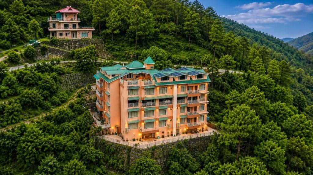 an aerial view of a building on a mountain at Rajgriha Luxury Kasauli Stay in Kasauli