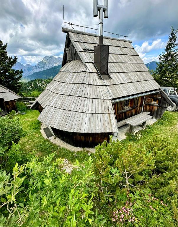 a building with a roof with a cross on it at Koča Velika Planina - Chalet Kamrica in Stahovica
