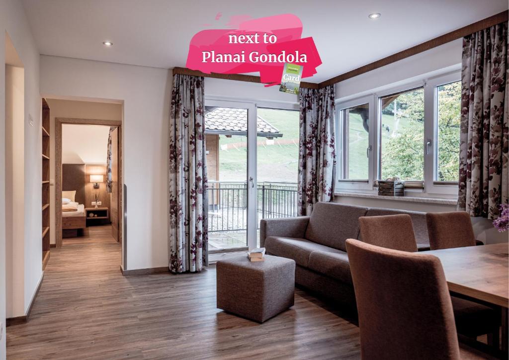 a living room with a couch and a table at Die Barbara Appartements & Zimmer in Schladming