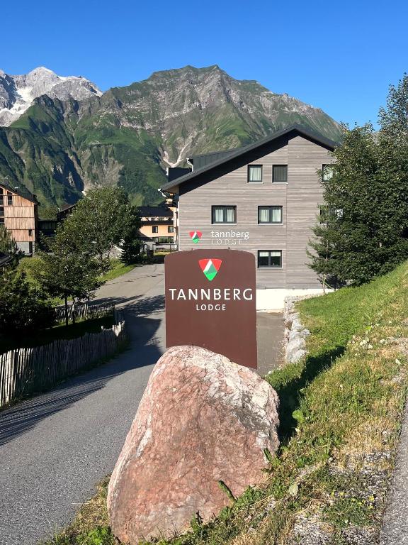a sign with a rock in front of a building at tannberg LODGE in Schröcken