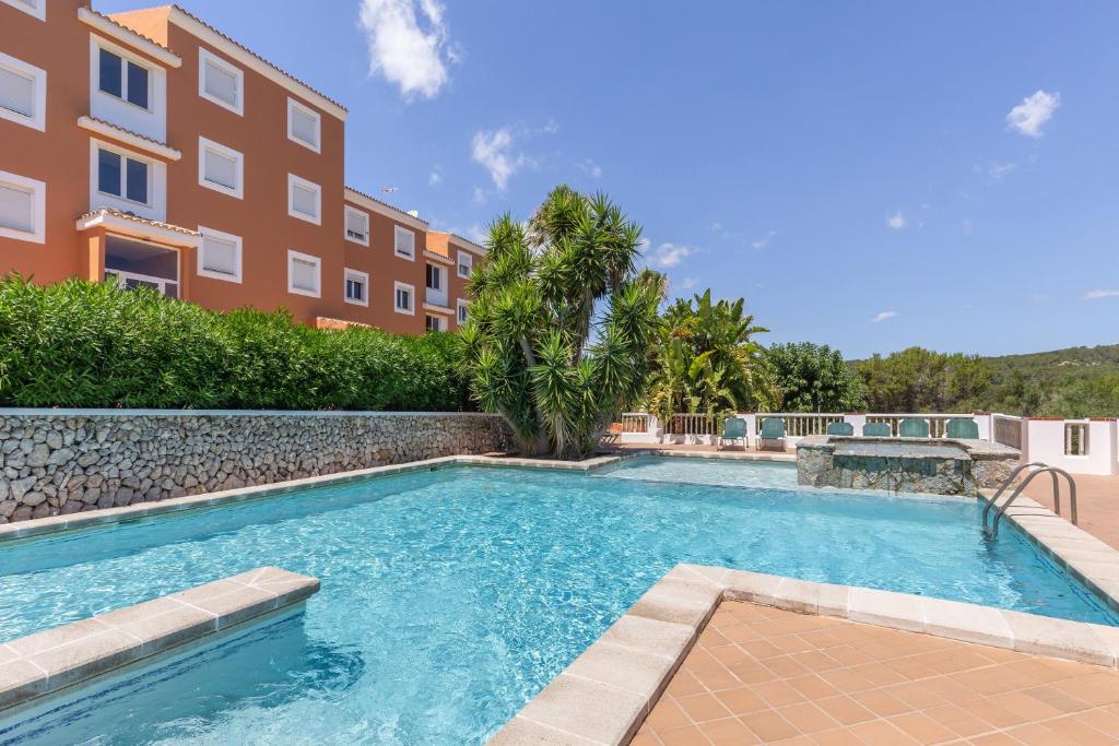 a swimming pool in front of a building at Son Bou Pool and Sea in Son Bou