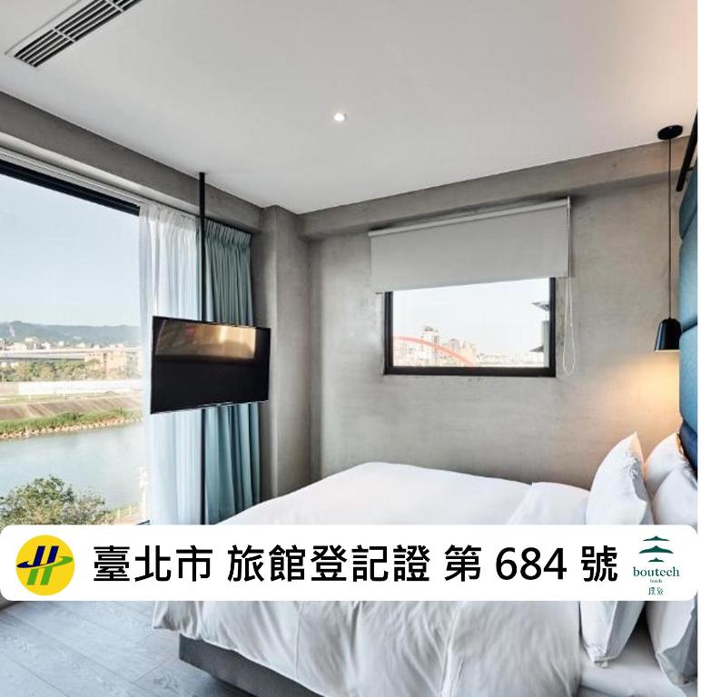 a bedroom with a bed and a window at Waterfront Hotel in Taipei
