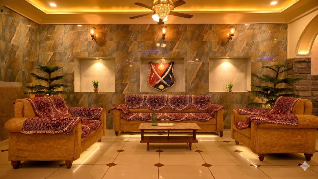 a living room with two couches and a table at Virasat Mahal - Jaipur City Centre Hotel in Jaipur