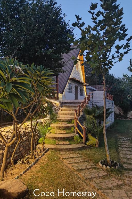 a set of stairs leading to a house at Coco Homes Katra in Katra