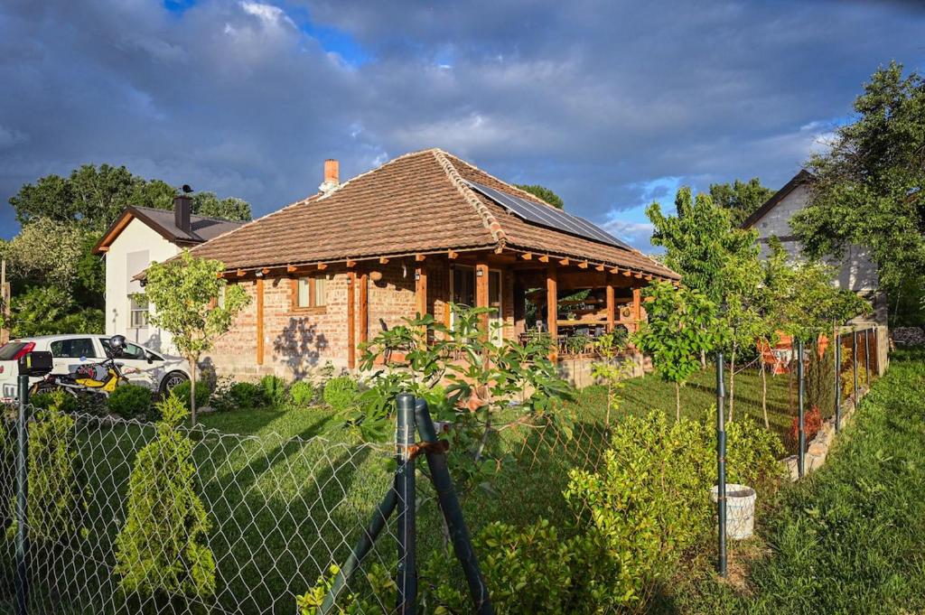 a wooden house with a fence in front of it at Etno kuca Drina in Loznica