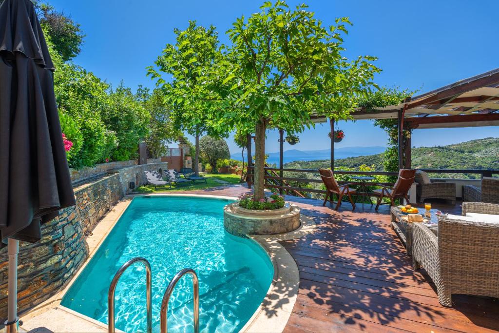 a swimming pool with a tree in the middle at Aenaon Villa with Private Pool Panoramic view in Mileai