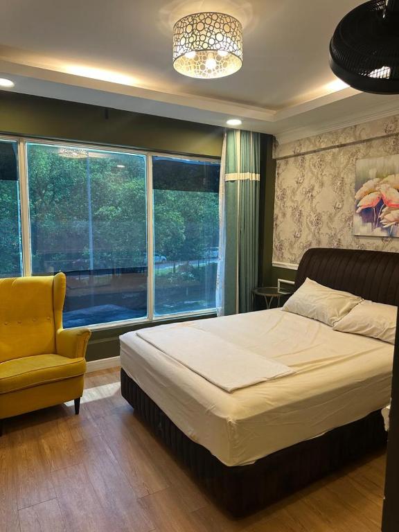a bedroom with a bed and a chair and a window at Guest Room Star Avenue in Shah Alam
