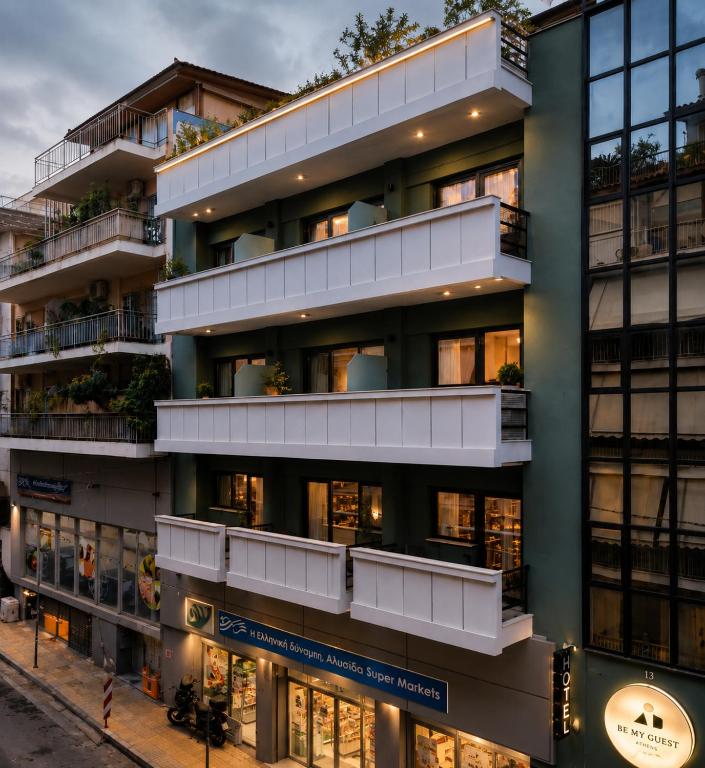 an apartment building with balconies on a city street at Be My Guest Athens in Athens