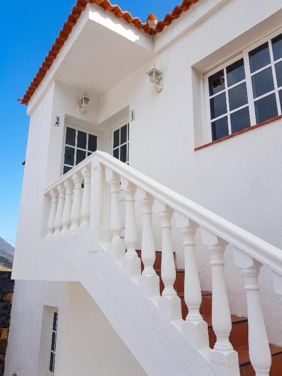 a white house with white stairs at Modern apartment in Frontera, 45 m² with sea view balcony in Frontera