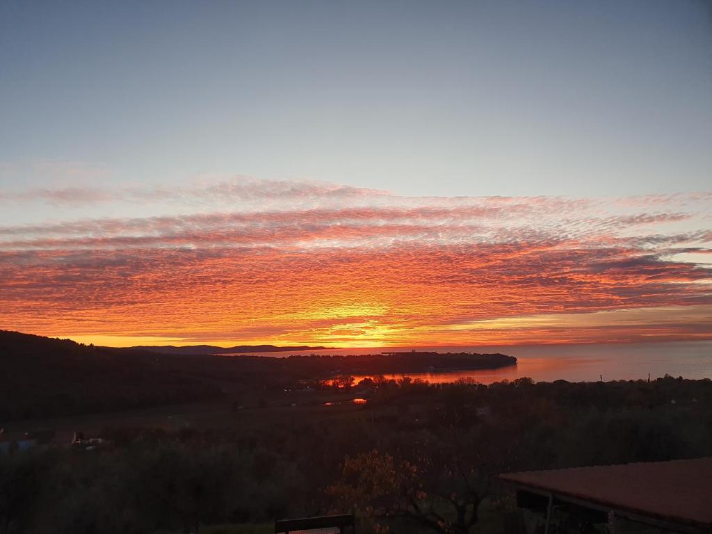 a sunset over a body of water at B&B Tramonti sull'Adriatico in Muggia