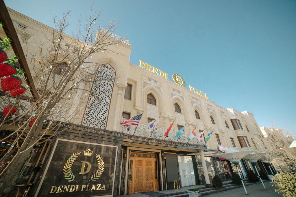 a grand palais building with american flags on it at Dendi hotel bukhara in Bukhara