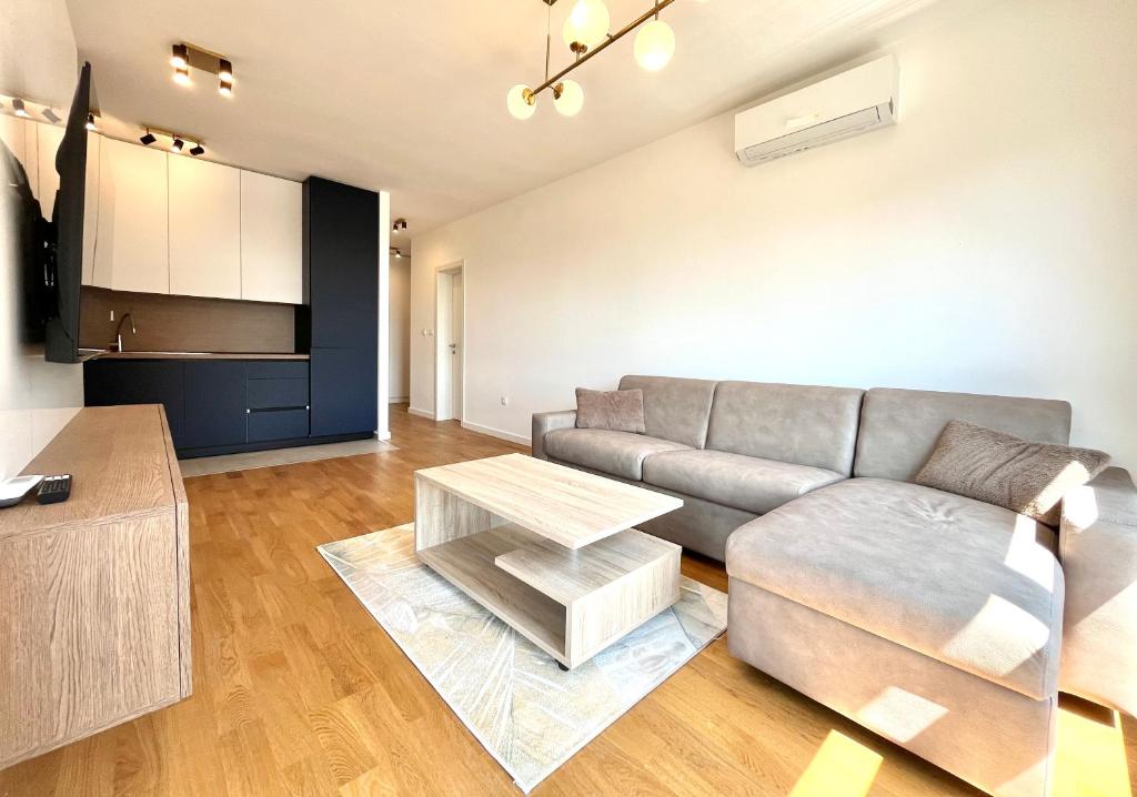 a living room with a couch and a table at 1bd New and Modern Apt with Sea View "Blue Horizon" in Bar