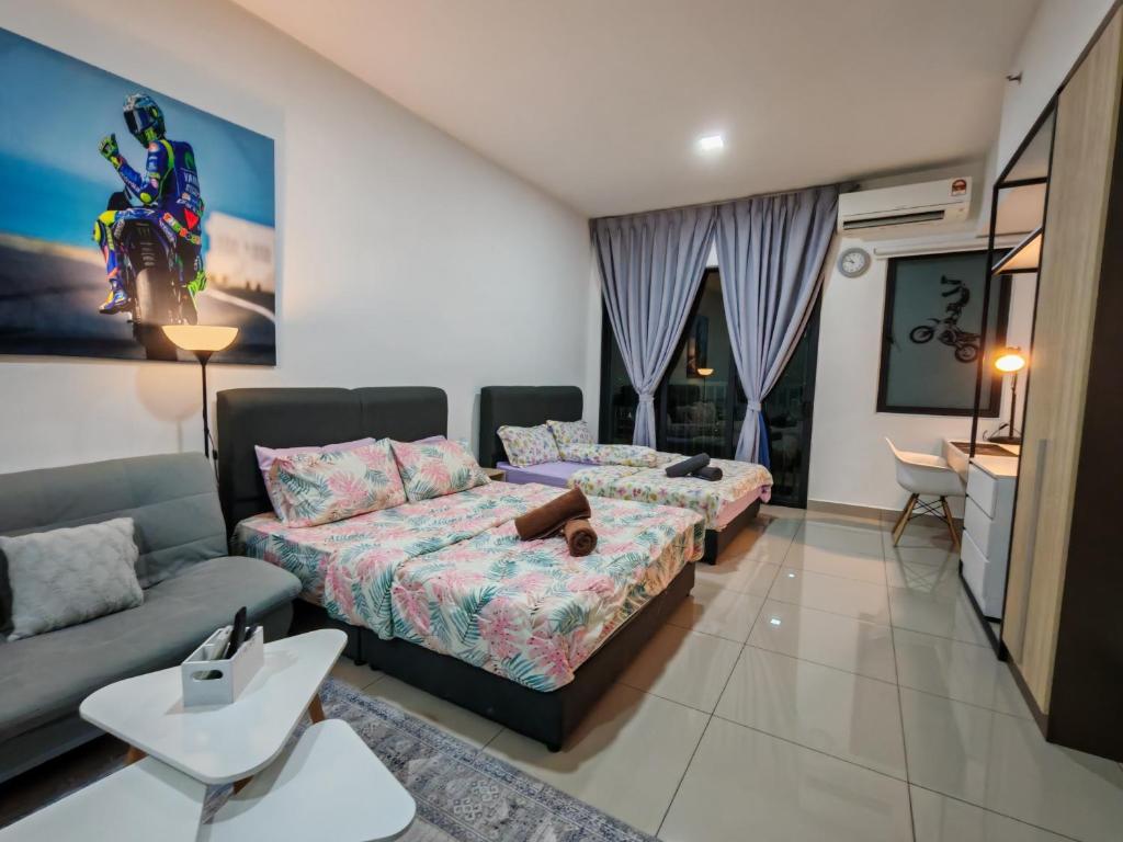 a living room with two beds and a couch at Alinea Suites Shah Alam in Shah Alam