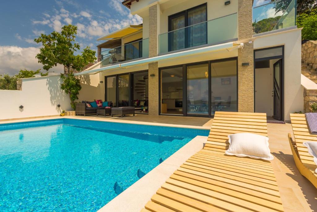 a villa with a swimming pool and a house at Villa VI in Dubrovnik