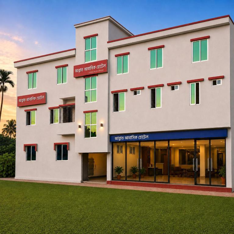 a large white building with red and green windows at Jannat Residential Hotel in Atgaon