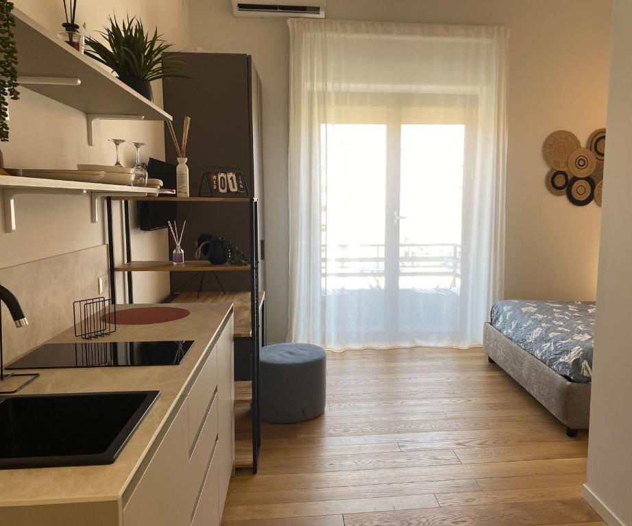 a kitchen with a sink and a window in a room at Cavour 106 Apartment in Palermo