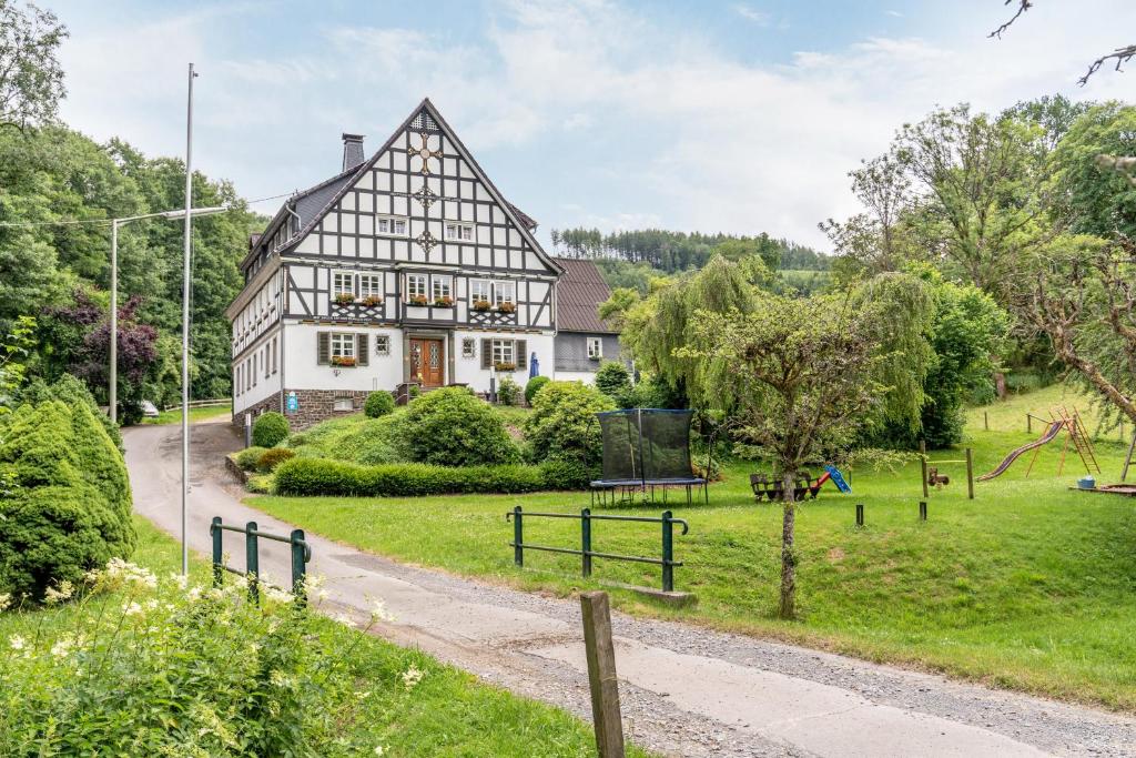 an old house with a park in front of it at Haus Hermes in Kirchhundem