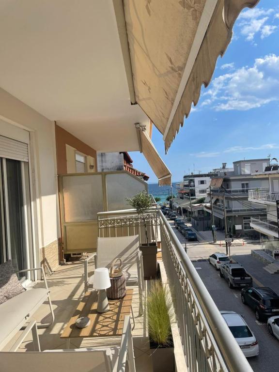 a balcony with a view of a parking lot at Sea And Sand Apartment in Nea Kallikrateia