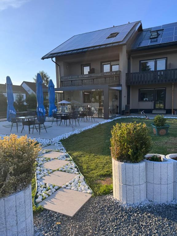 a house with blue umbrellas and a patio at Villa Johannes in Warmensteinach