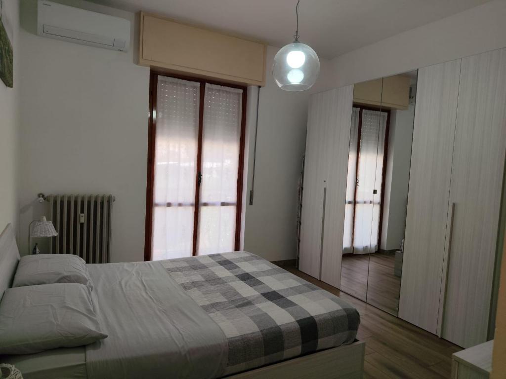 a bedroom with a bed with a checkered blanket at Casa Patrik in Pietra Ligure