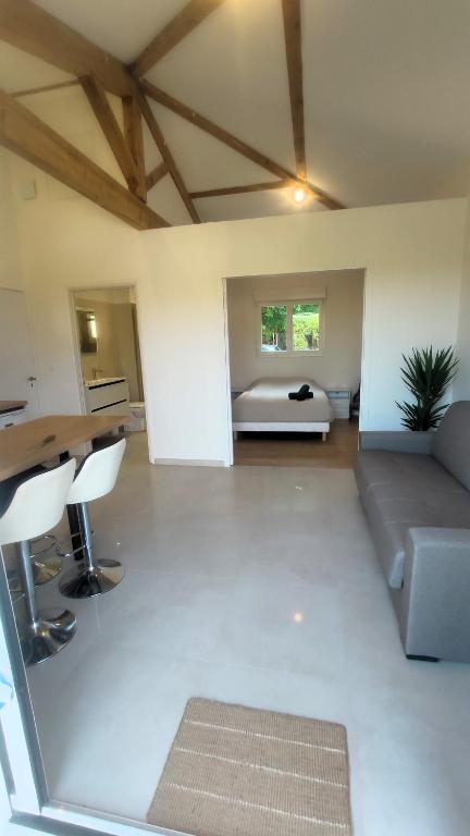 a living room with a couch and a table at Pause au coeur des Côtes-Rôtie in Ampuis