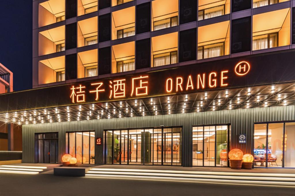 an orange sign on the front of a building at Orange Hotel Changbaishan Erdaobaihe in Antu