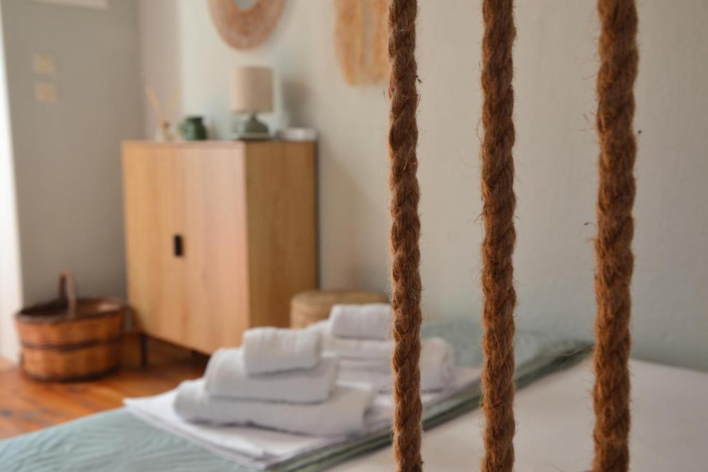a pile of towels sitting on top of a bed at Coralia Nest Studio in Glossa