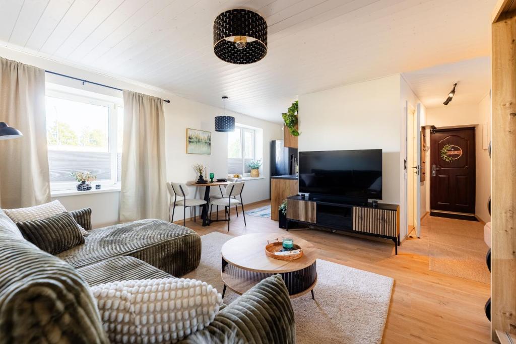 a living room with a couch and a table at Marie` Apartment in Salme