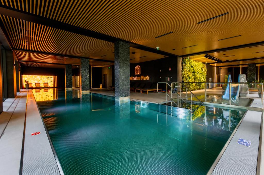 a large swimming pool in a building at Polanica Park, Sun&Snow in Polanica-Zdrój