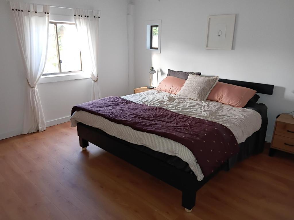 a bedroom with a bed and a window at Fairview Retreat in Clunes