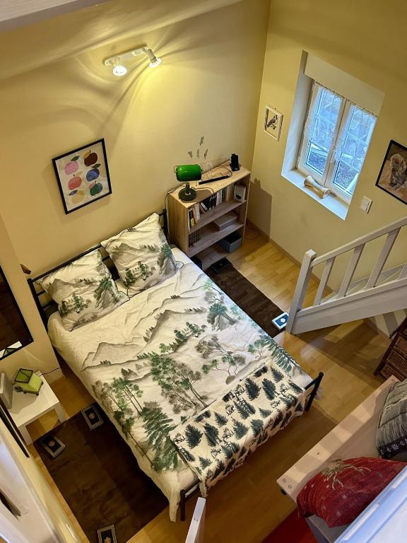 a small room with a bed and a desk at L Ecureuil Ludique in Beaumont-le-Roger