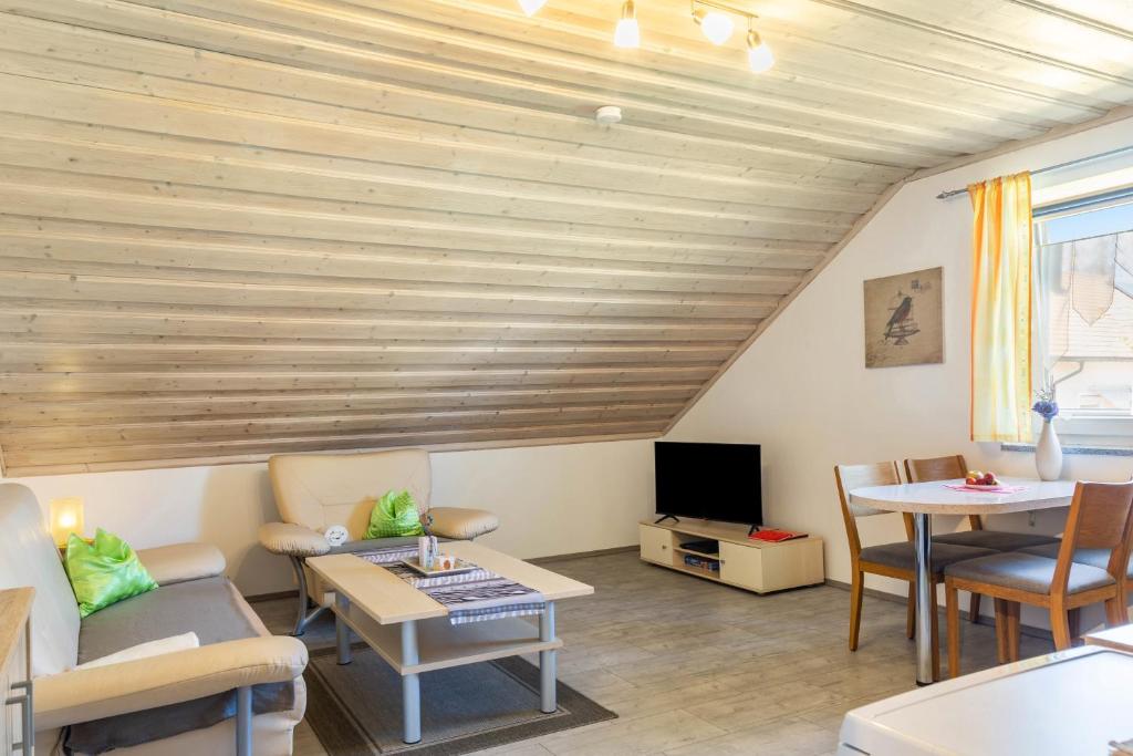 a living room with a couch and a table at Die Moderne Fewo in Breitenberg